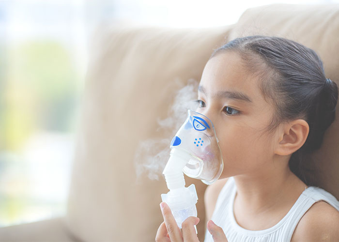 Image of child wearing nebulizer equipment