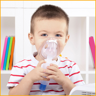 little boy using nebulizer